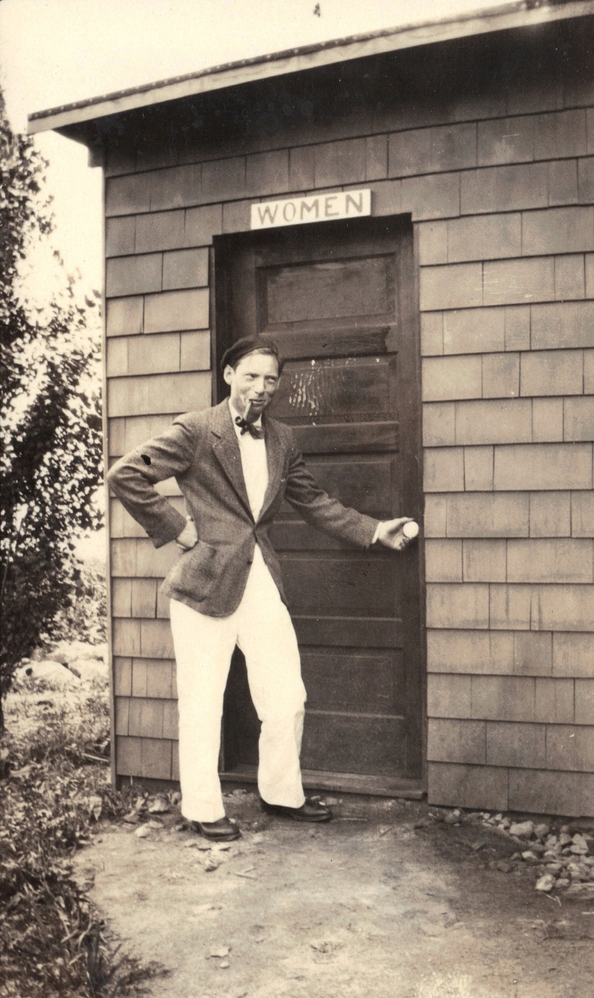 Portrait of Louis Kahn around age 24 in front of cabin 