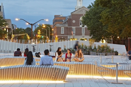The plaza at Harvard with people using a large public seating area.