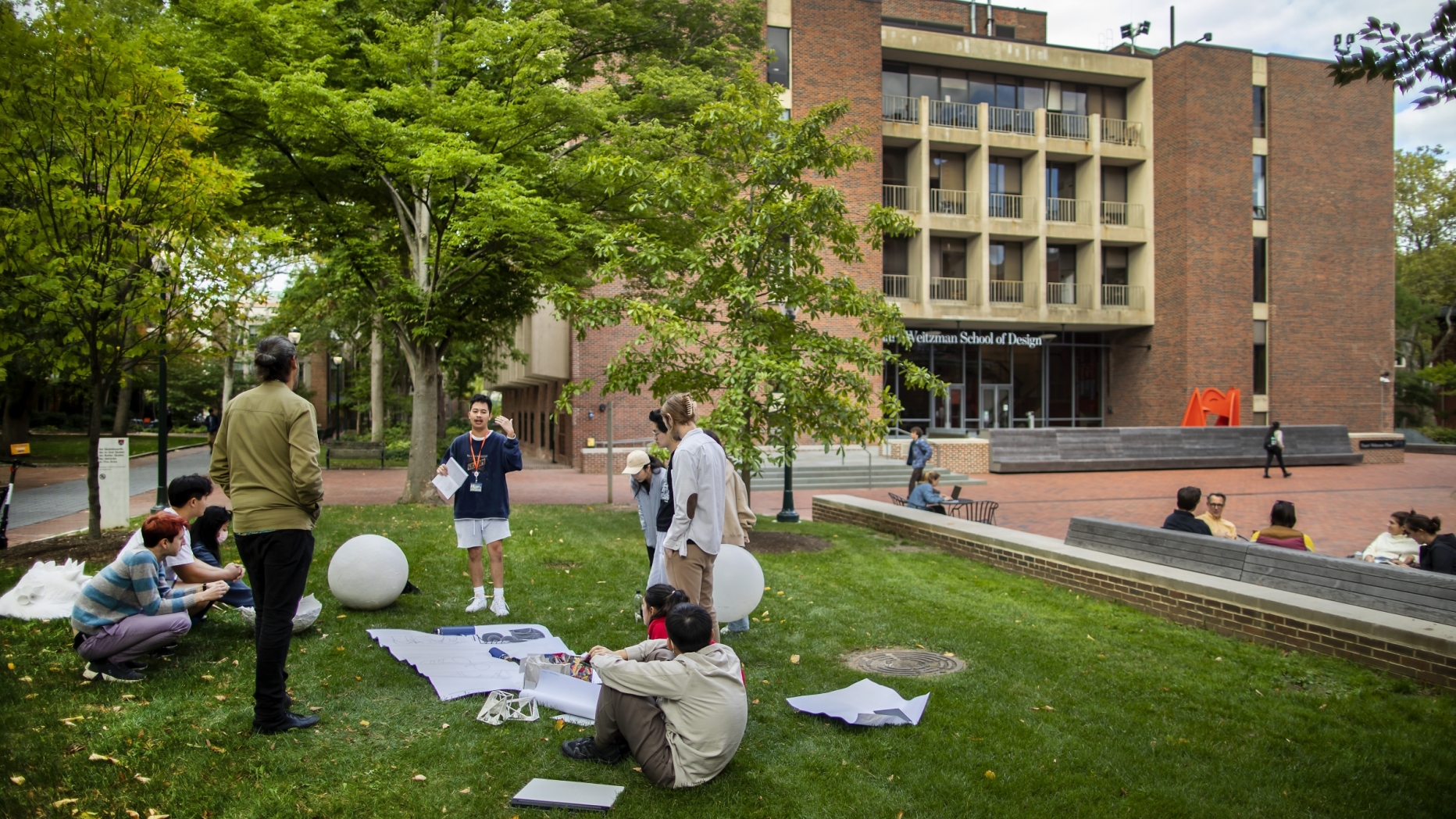 Students working on a lawn outside of Meyerson Hall