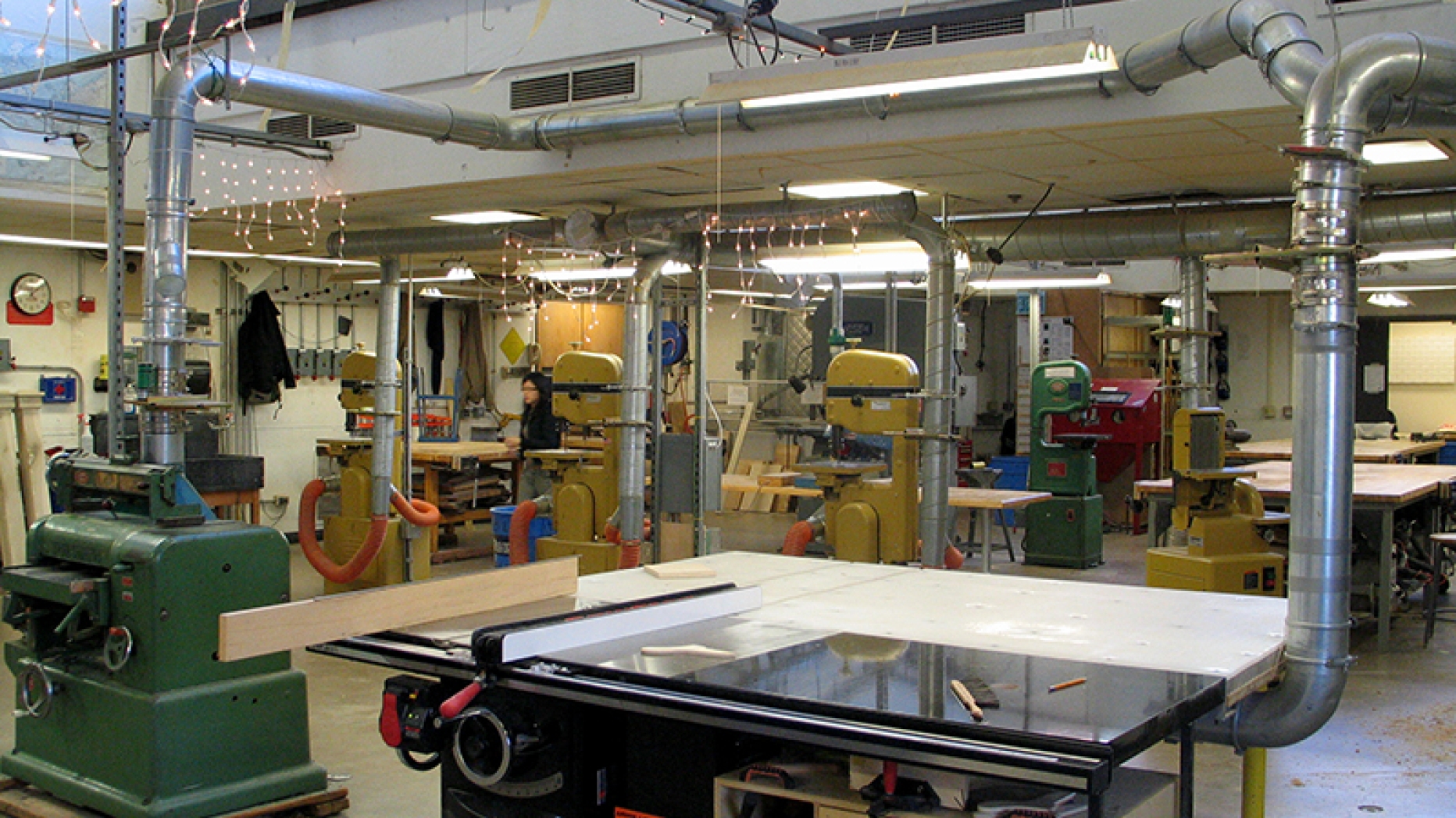 Unoccupied fabrication lab with a variety of machine tools spread throughout the lab