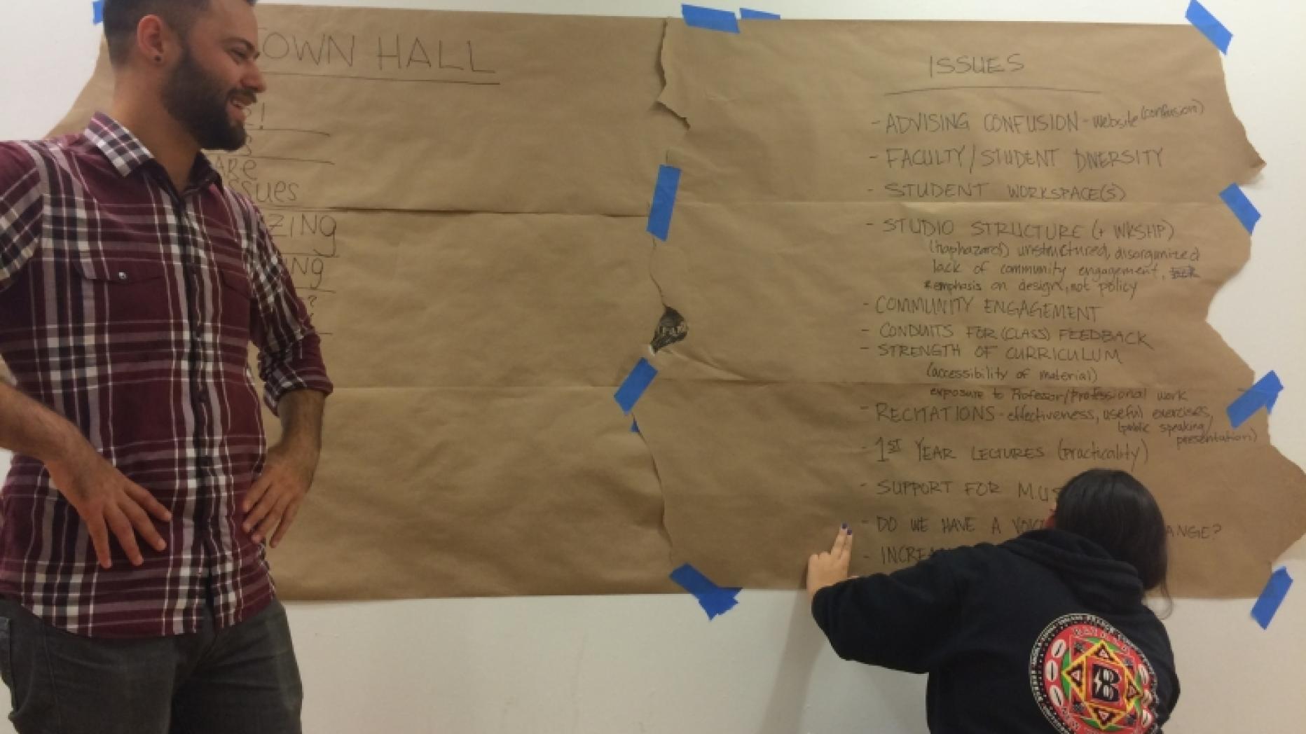 Students posting message board for town hall meeting.