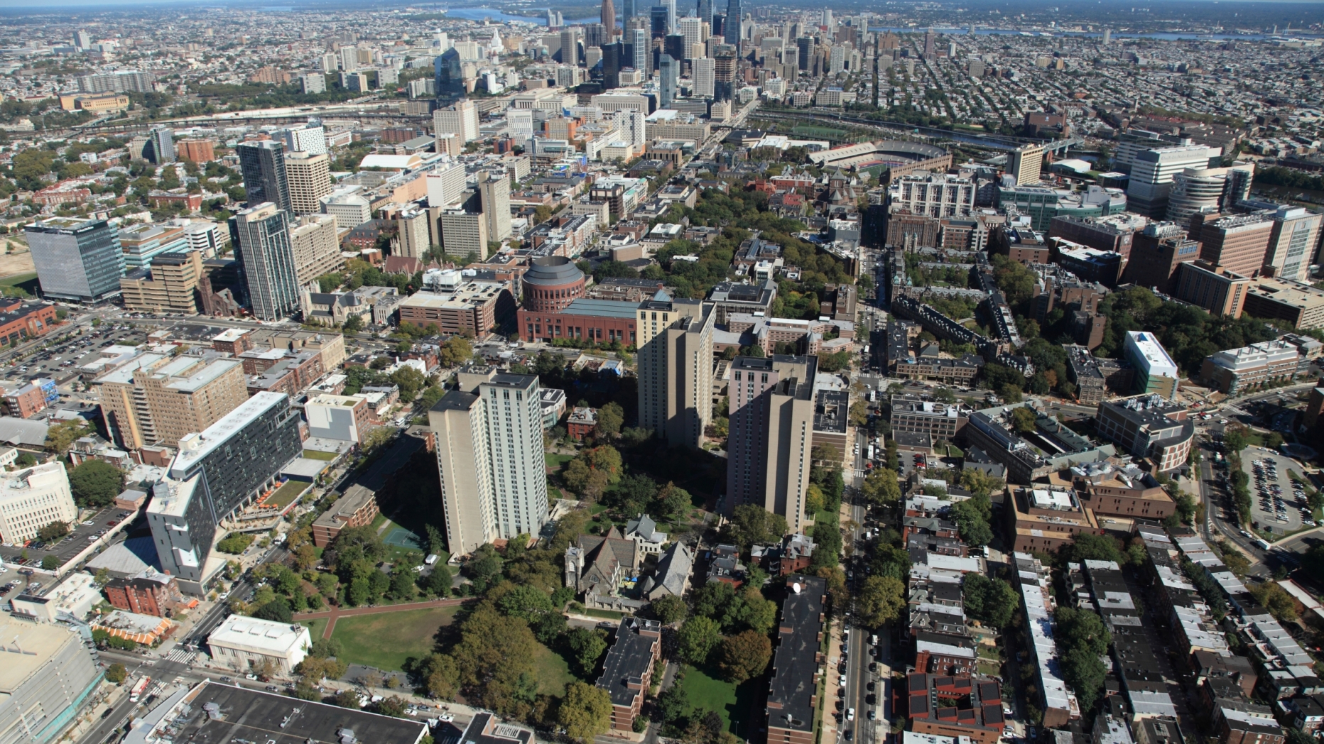 Aerial view of UPenn campus with Philadelphia skyline in the background