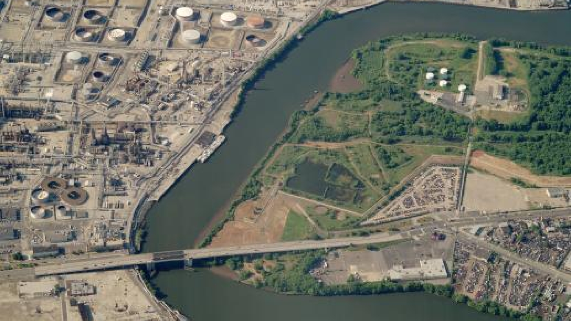 A birds eye view of a section of the Lower Schuylkill area containing an oil refinery and the Passayunk avenue bridge.