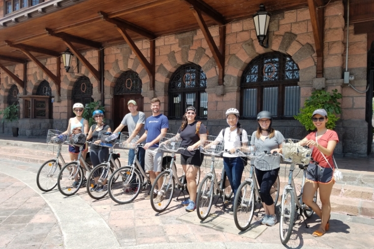 Group photo of cyclists with bikes