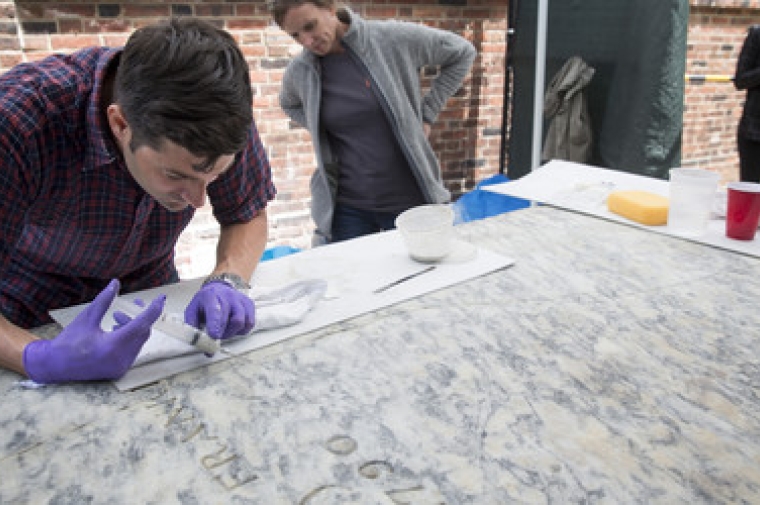 Using a syringe filled with a breathable, lime-based injection grout, Federico and his team filled the voids of Franklin’s marble grave marker.