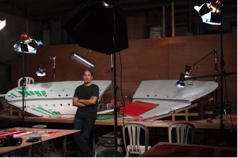 Photograph of Paul Pfeiffer in his studio in front of a lighting and photography setup of one of 
