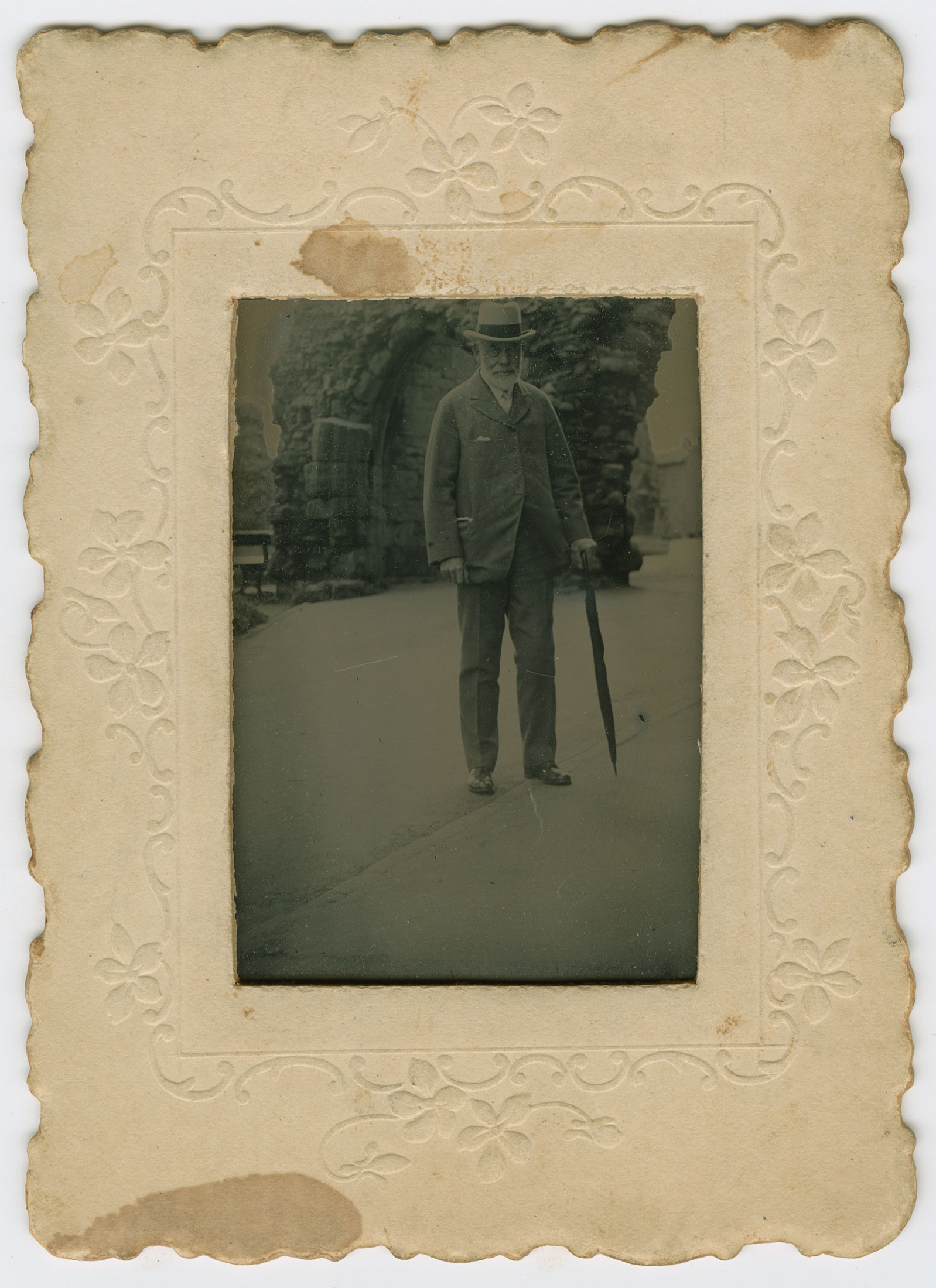 Sepia portrait of old man with cane