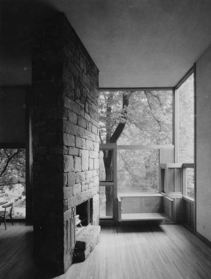 Black and white photograph of the interior of Fisher house showing window seat and fireplace