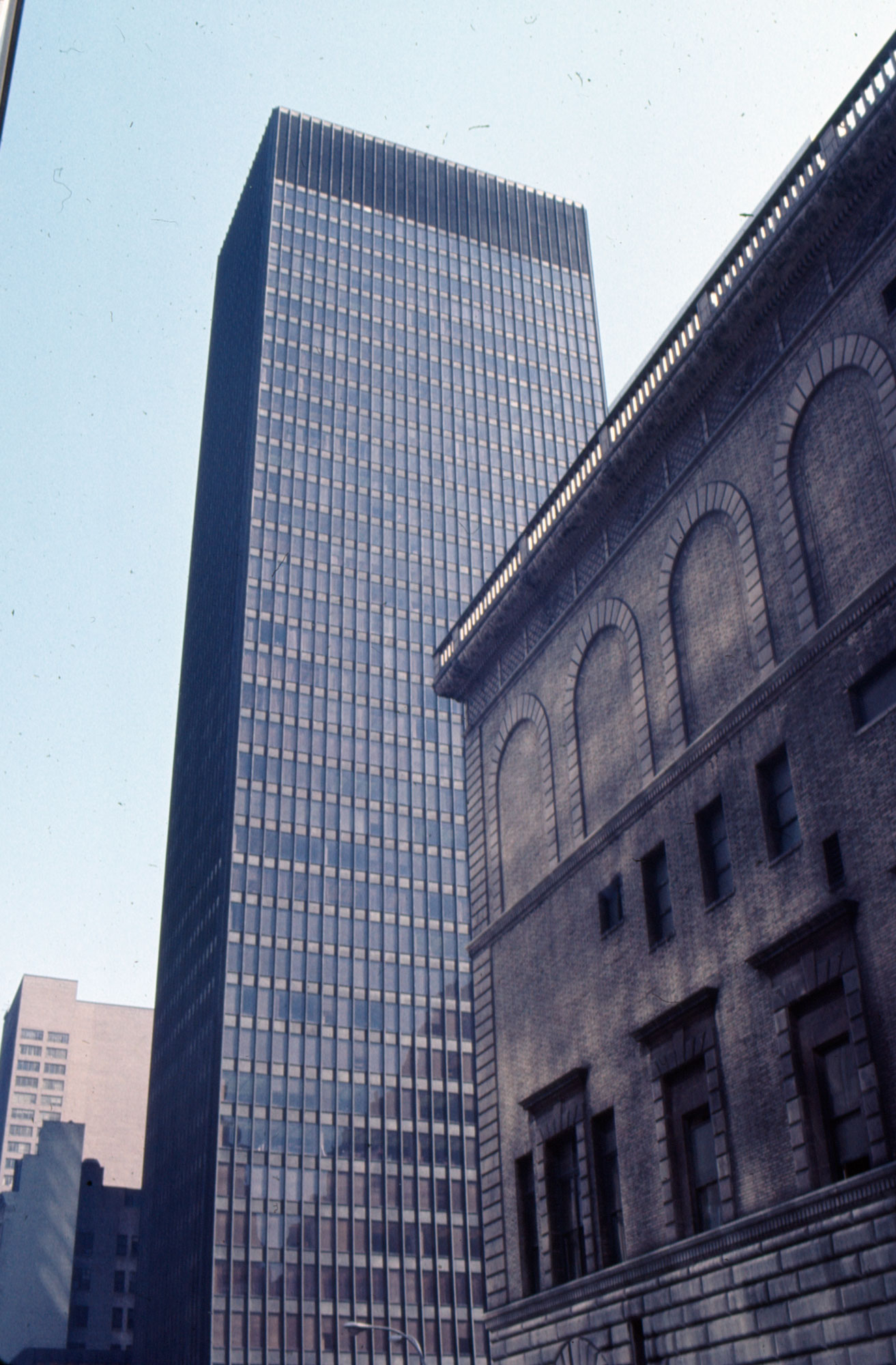 Color slide of glass skyscraper next to an historic building