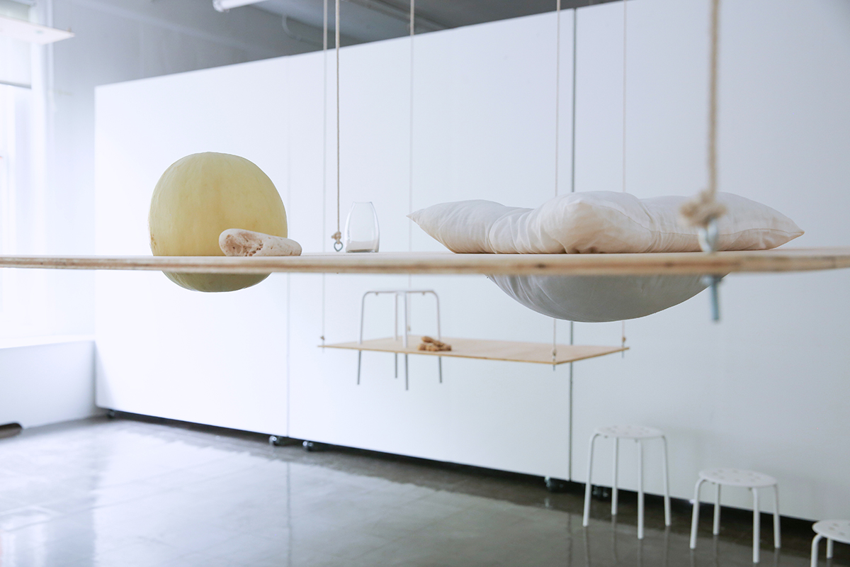 Artist installation with hanging wood and fabric elements