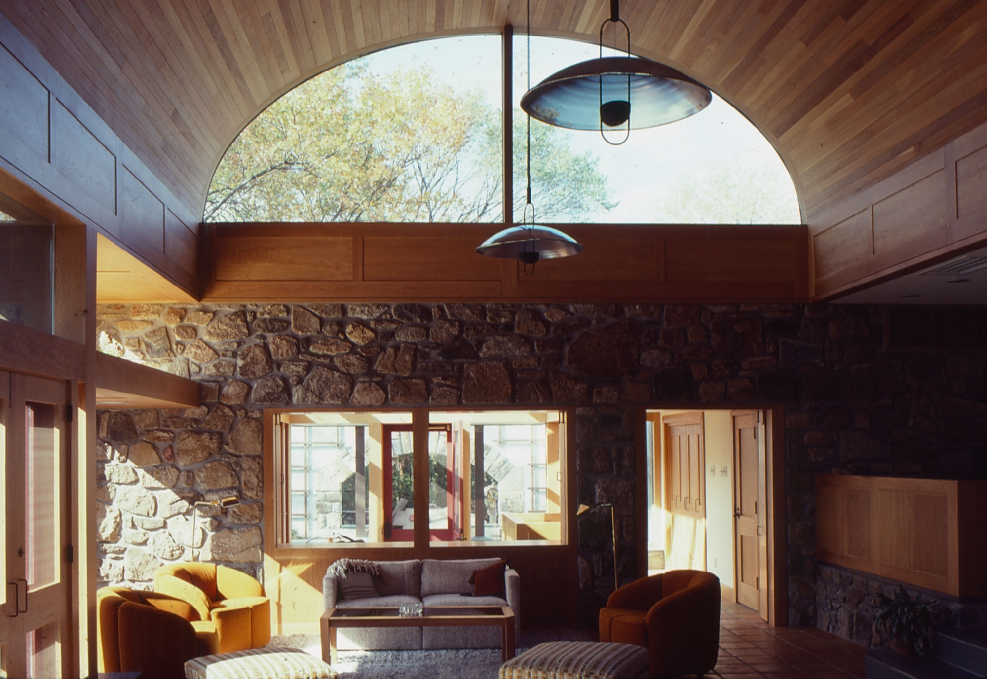 Color slide showing interior of house with large windows and wood paneling