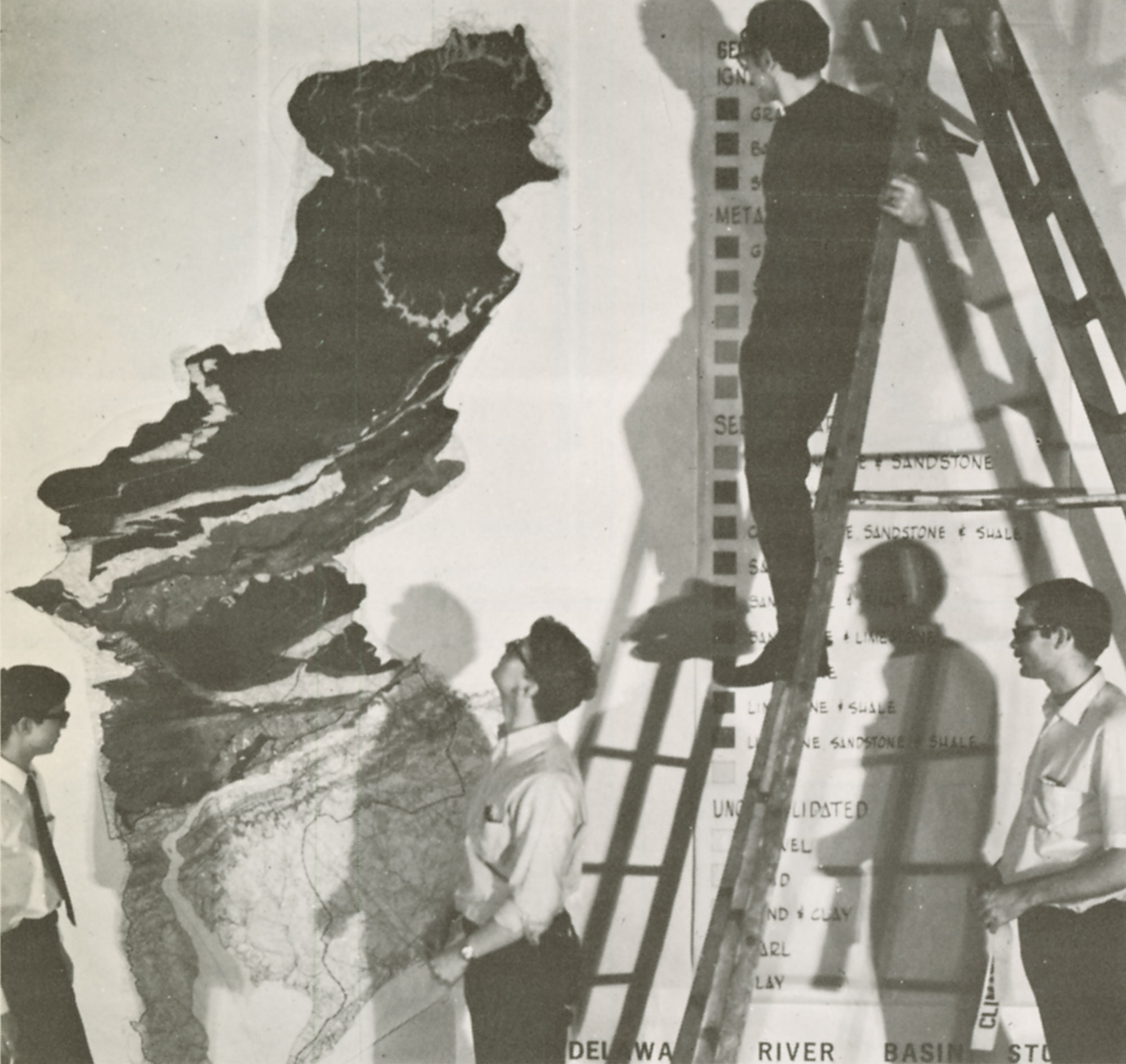 Black and white photo of students hanging map of Delaware River Basin in Meyerson Hall, ca. 1960
