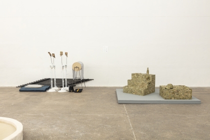 open gallery installation with concrete floor, featuring sculptures by students
