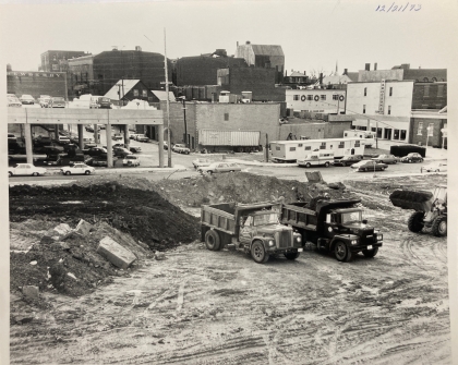 Black and white photo of demolished area and bulldozers