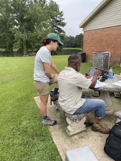 Man and woman working together outside with a drone on a table