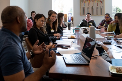 A group of people around a table at a meeting