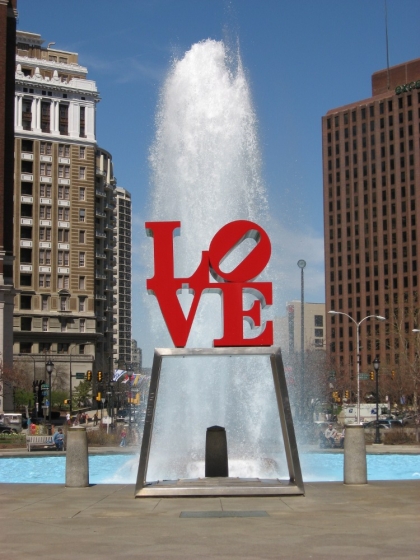 LOVE statue in Love park with fountain behind.