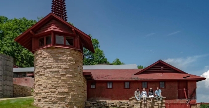 Barn connected to stone tower with steeple and weather vane