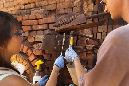 Two students working on a historic restoration and conservation project.