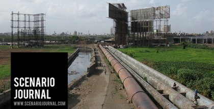 Pipeline along a canal in a grassy field