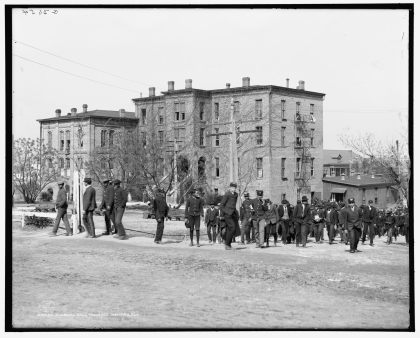 Black and white photo of a 4 story brick building