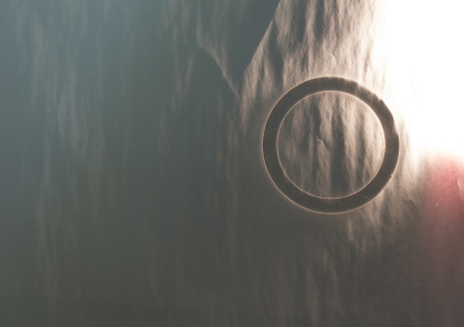 Slightly crumpled piece of paper with circle on it.