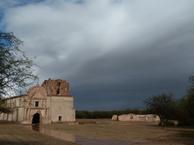 Photograph of dark storm clouds over a historic stone church