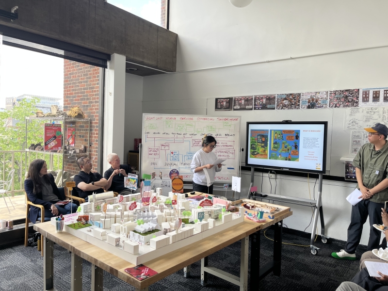 studio reviewers and presenters surround 5x5 foot model