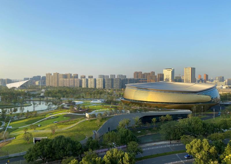 View across park from table tennis stadium to field hockey stadium