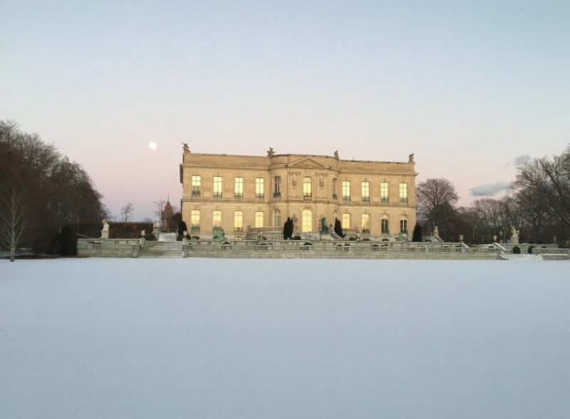 Mansion surrounded by snow covered grounds