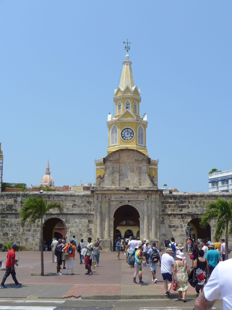 tourists in front of historic fort with clock tower