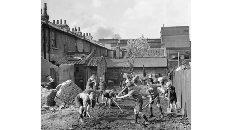 Young boys start to create an allotment on a bomb site