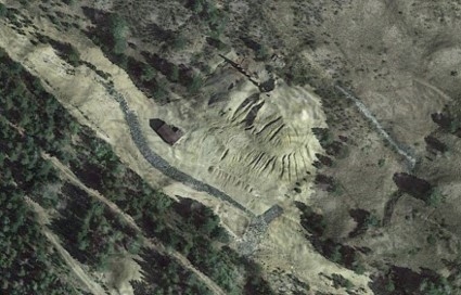 Satellite view of industrial mining dump. Border between green space and contaminated space is clearly defined