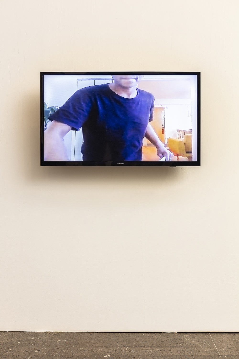 Image of man in black t-shirt on tv