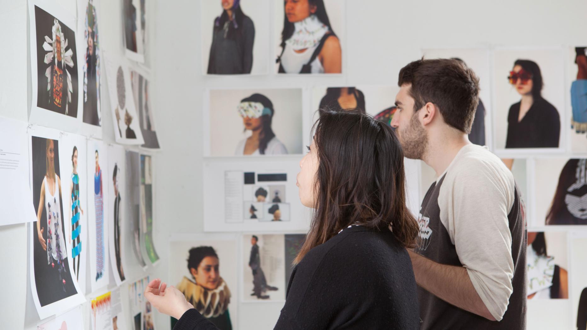 students look at art in an exhibit