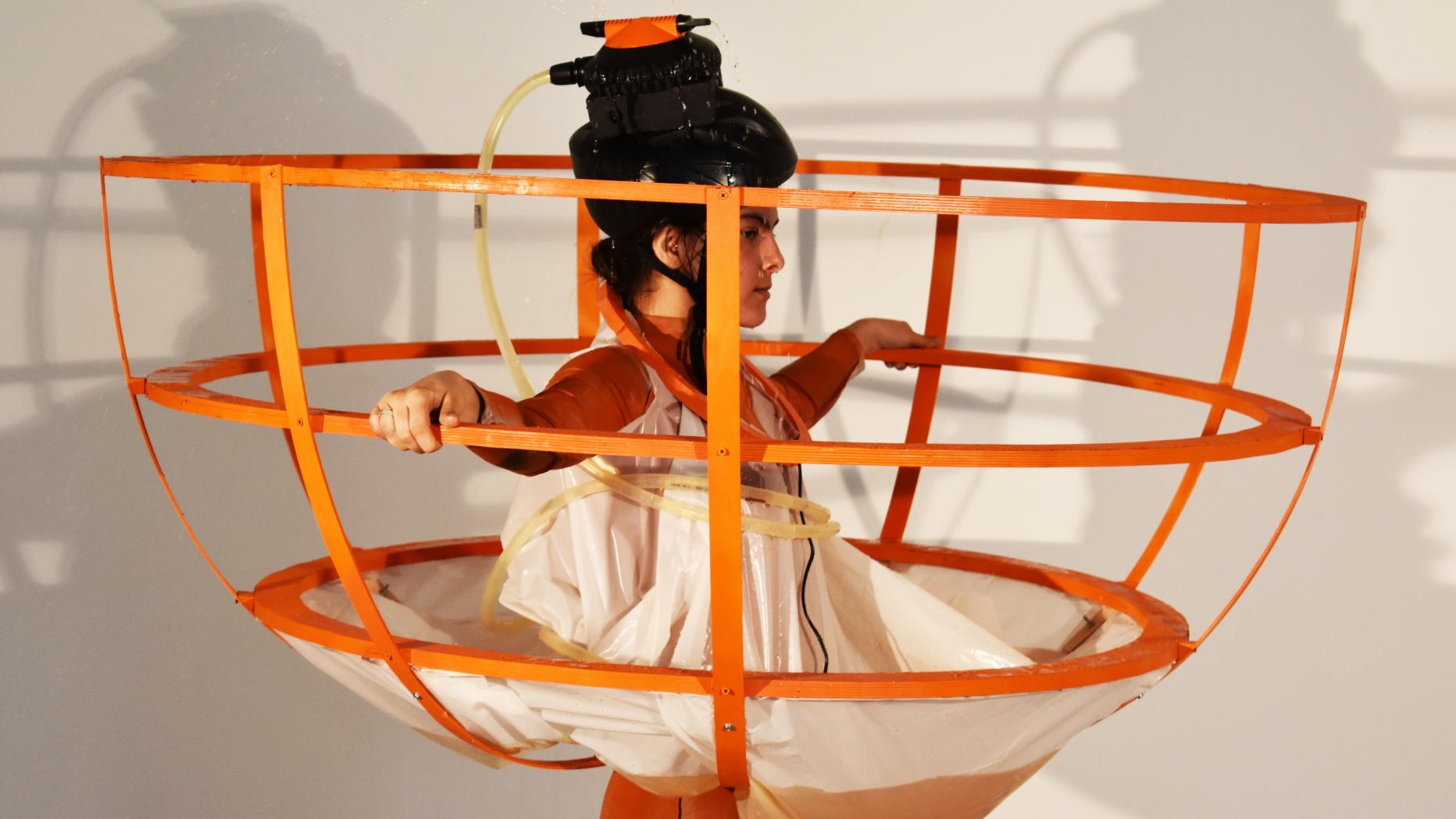 Woman using  power tool and crane to create performance art