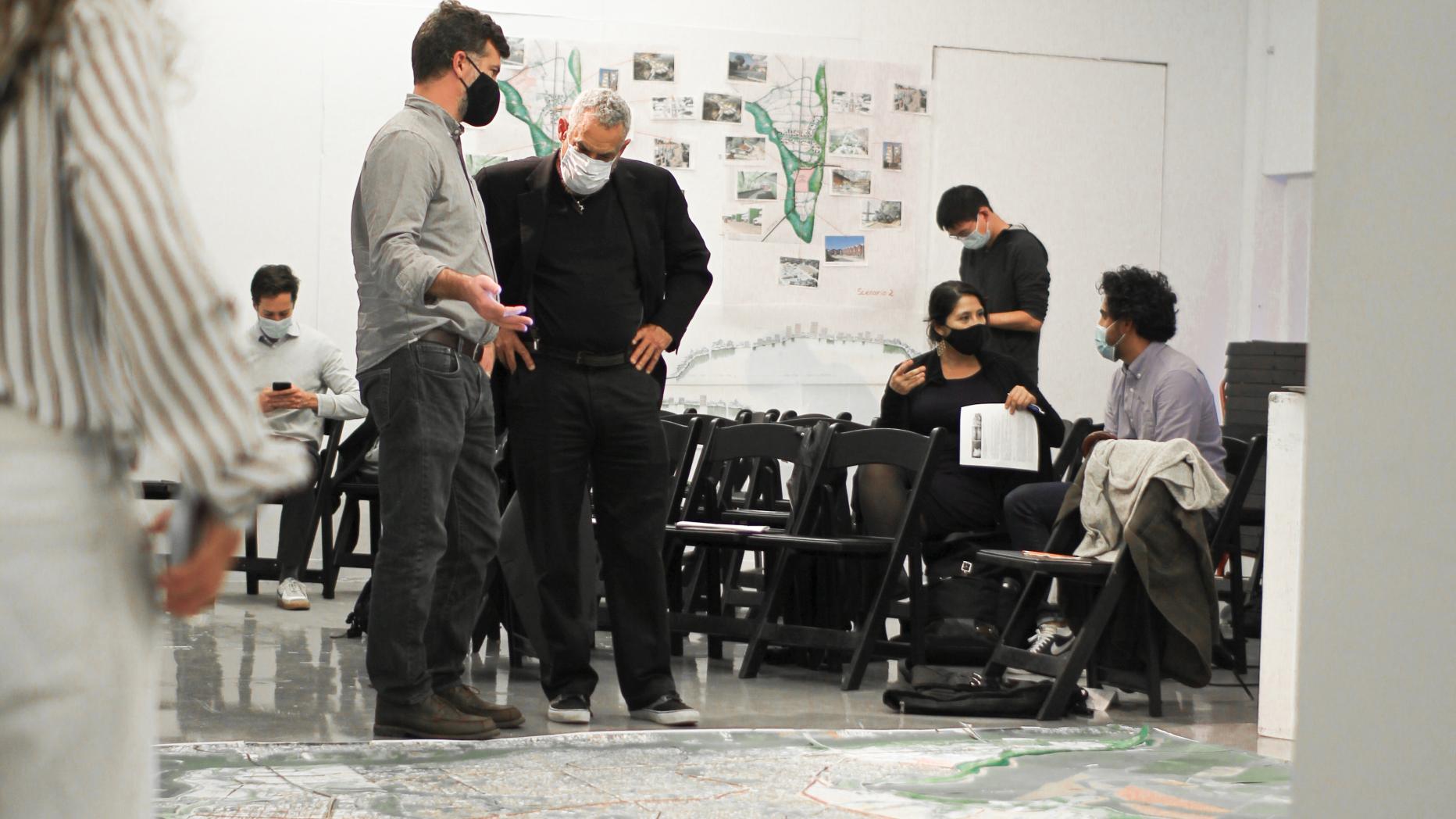 A group review with large maps on the ground