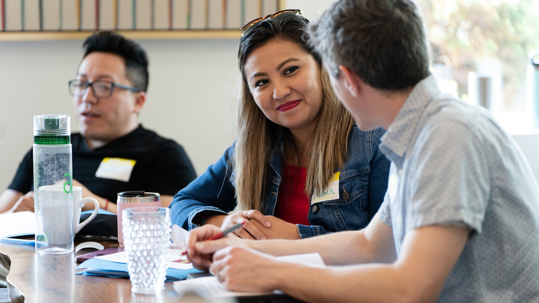 Three people meeting at a table