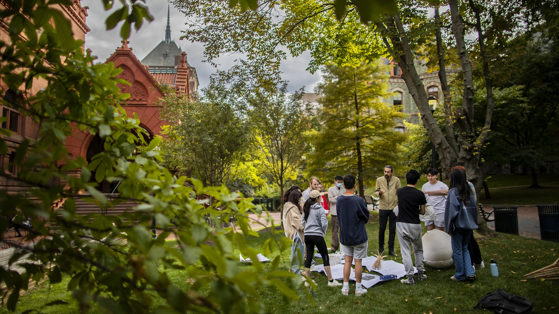 A group of students meet outside of Meyerson Hall