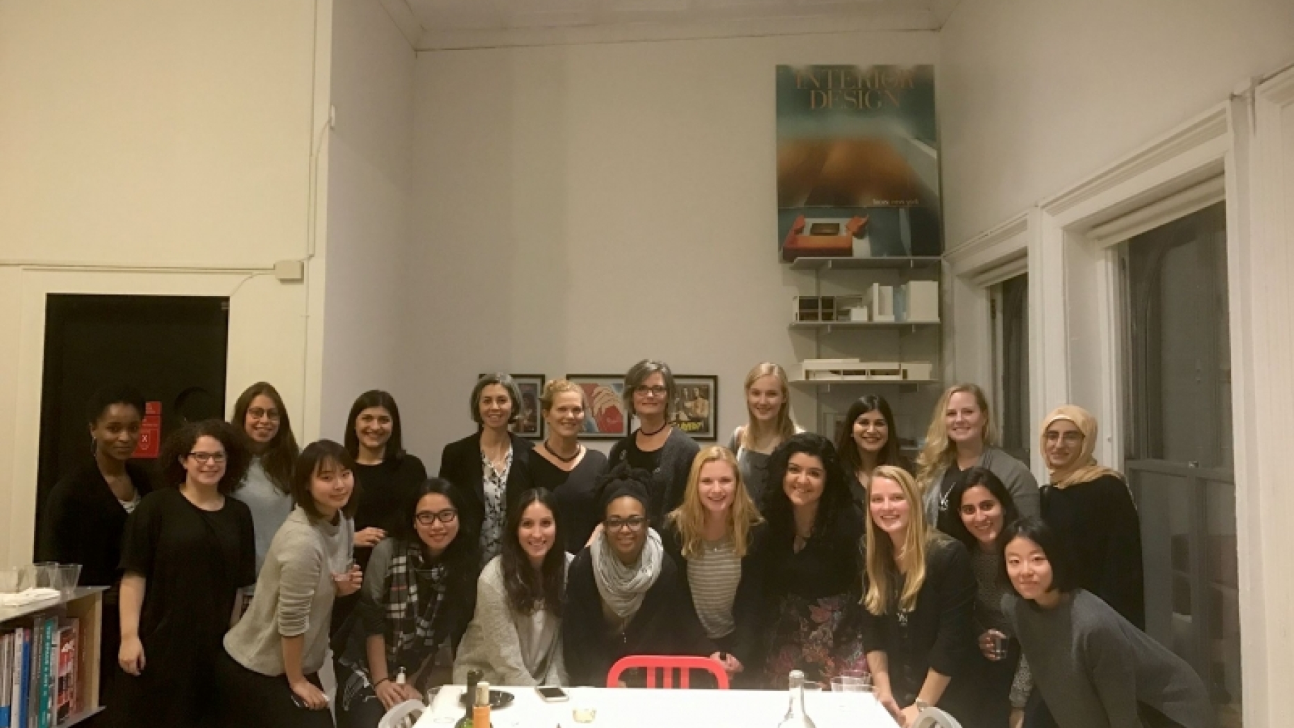 Group photo of event participants gathered around a table