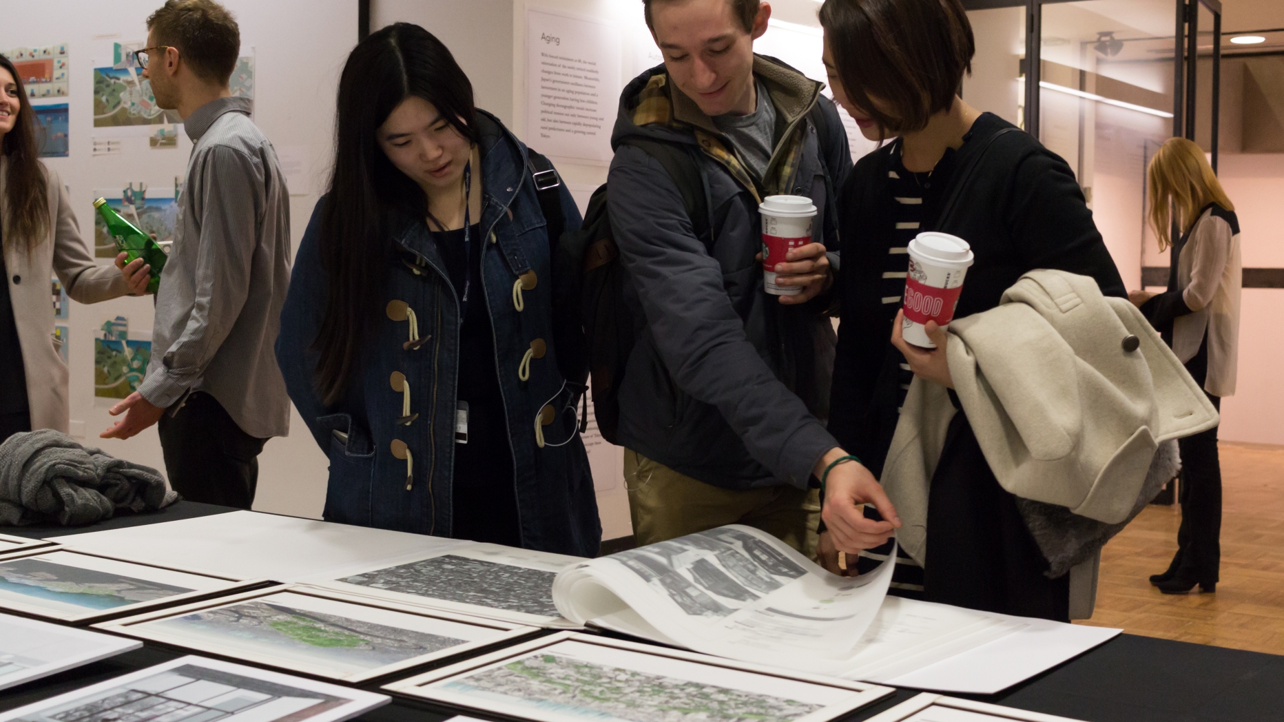 Students looking at material on a table.