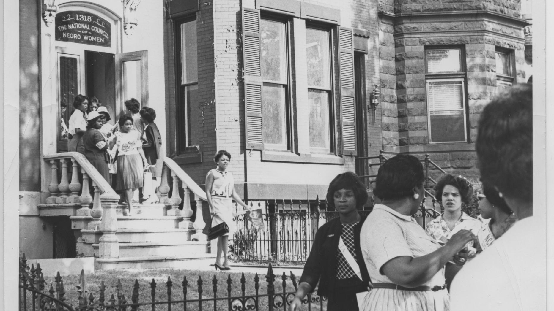 Black woman walking down steps of rowhouse