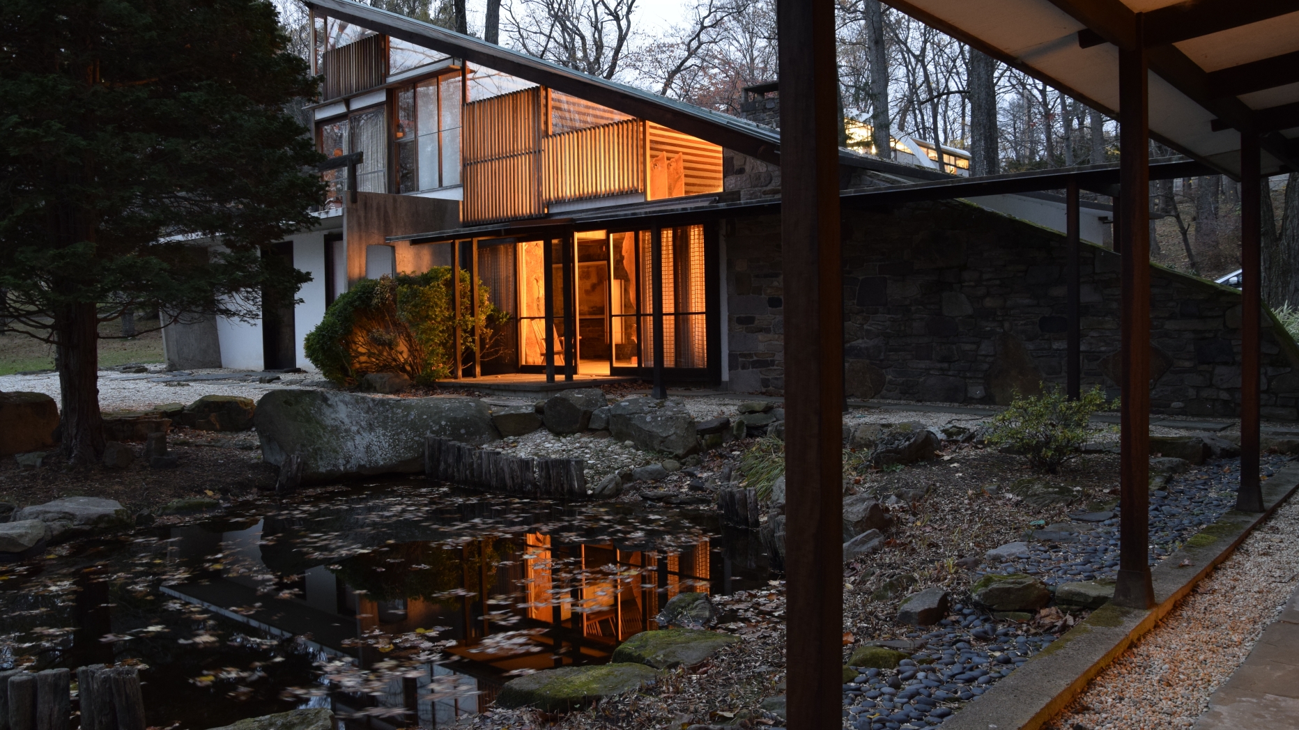 Arts building in the evening with pond in front.