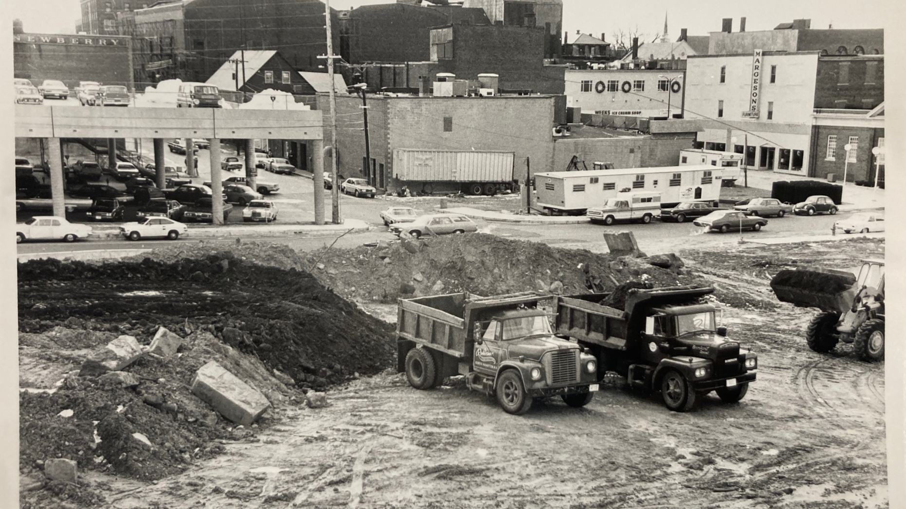 Black and white photo of demolished area and bulldozers