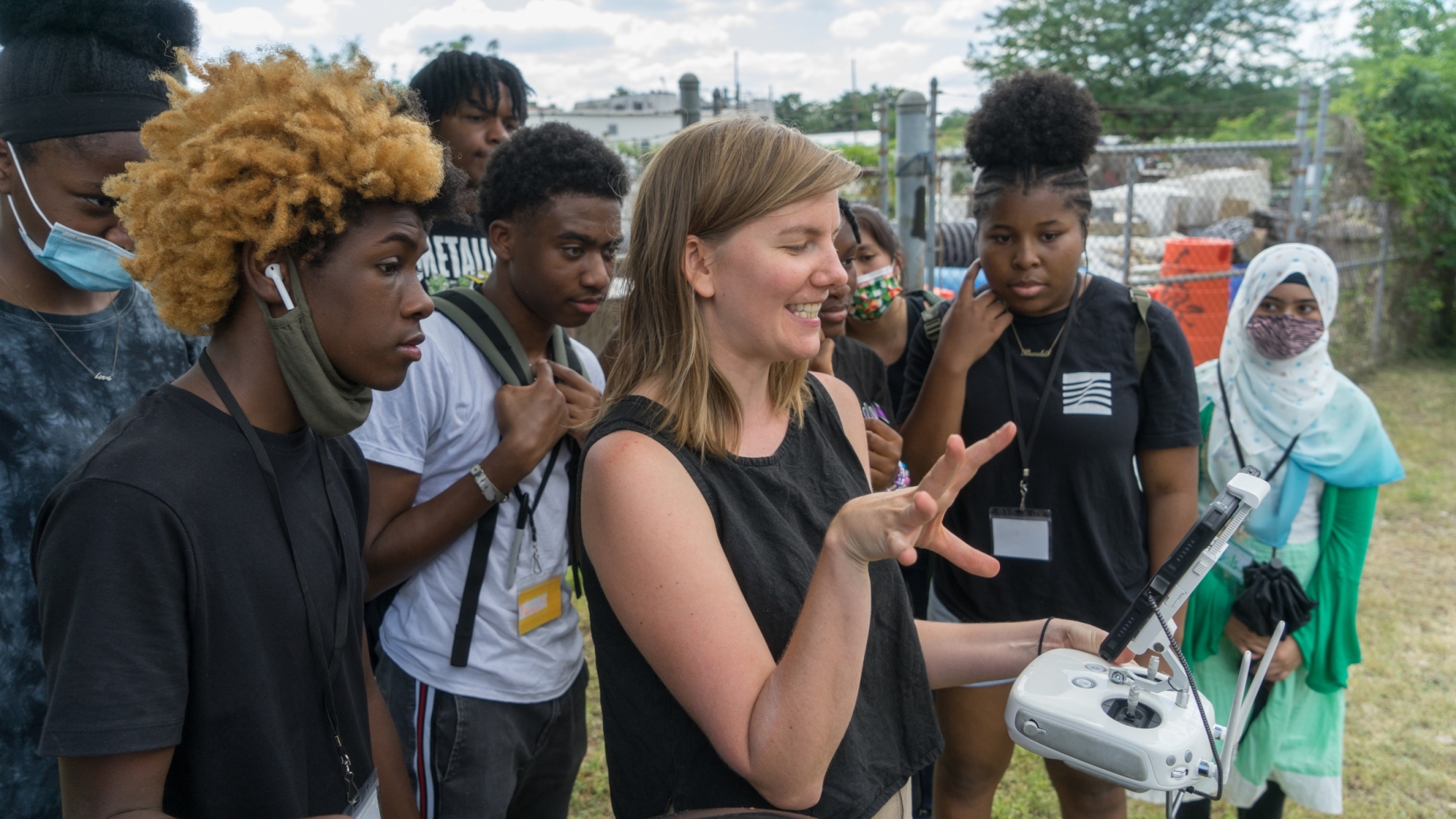 A group of people looking at an electrical device