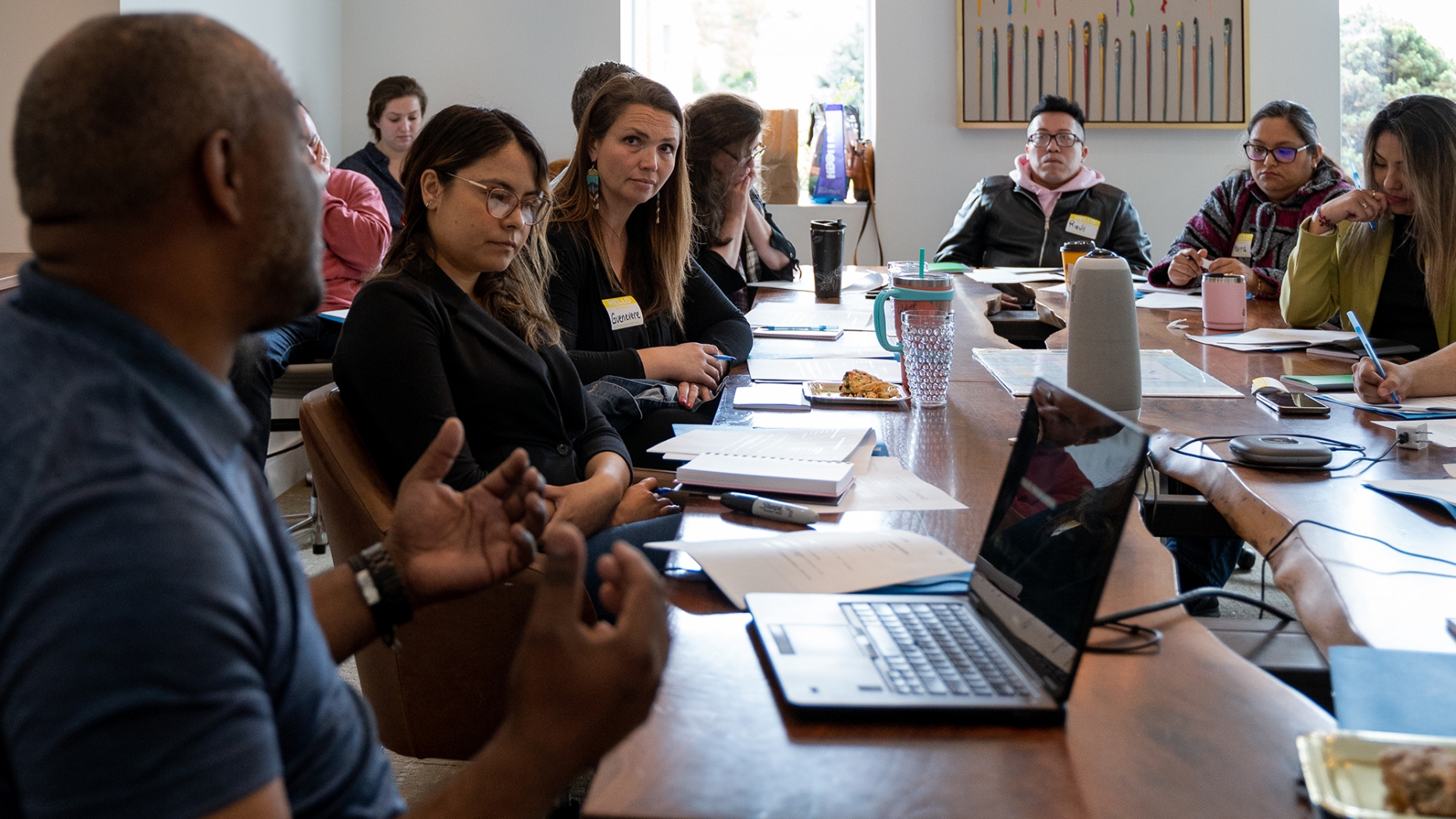 A group of people around a table at a meeting