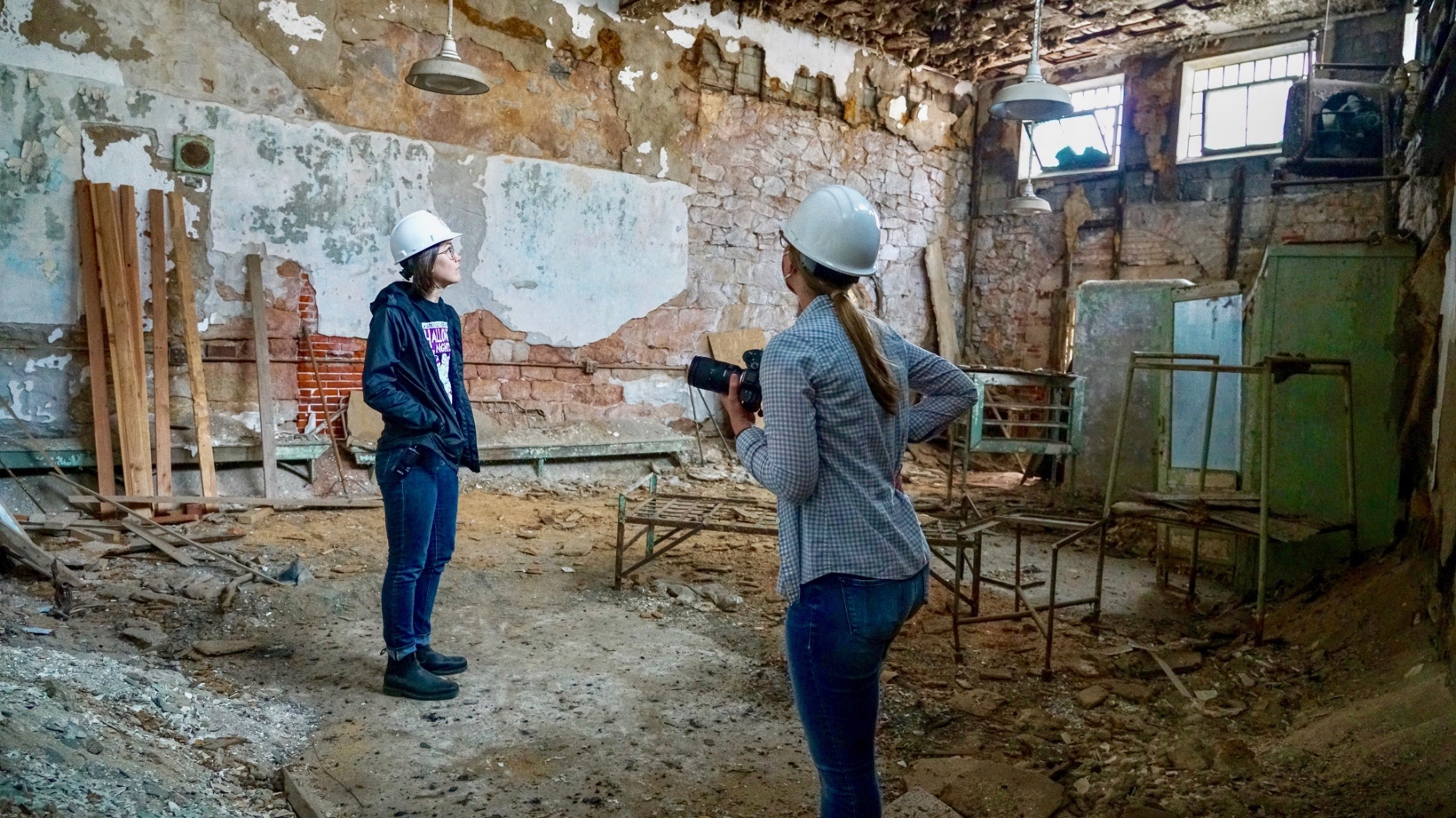 two people stand in architectural ruin