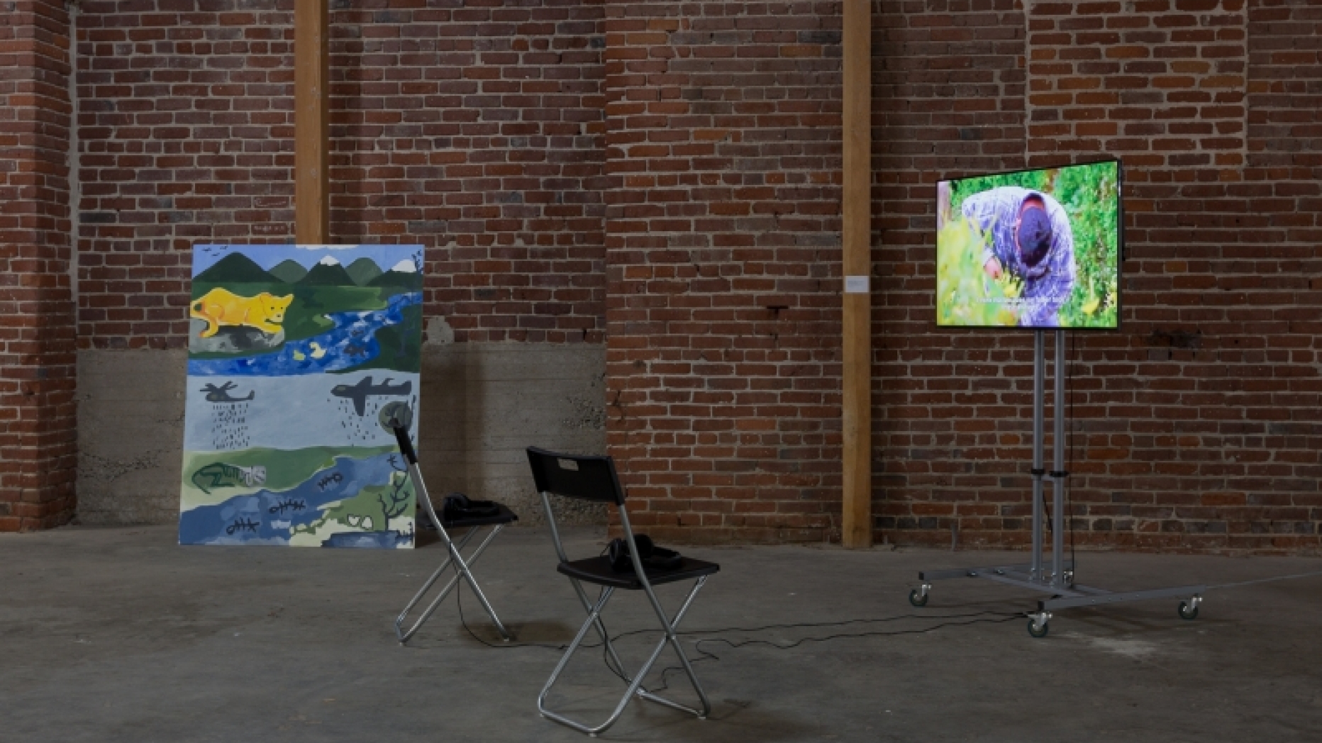Painting and monitor showing a video.