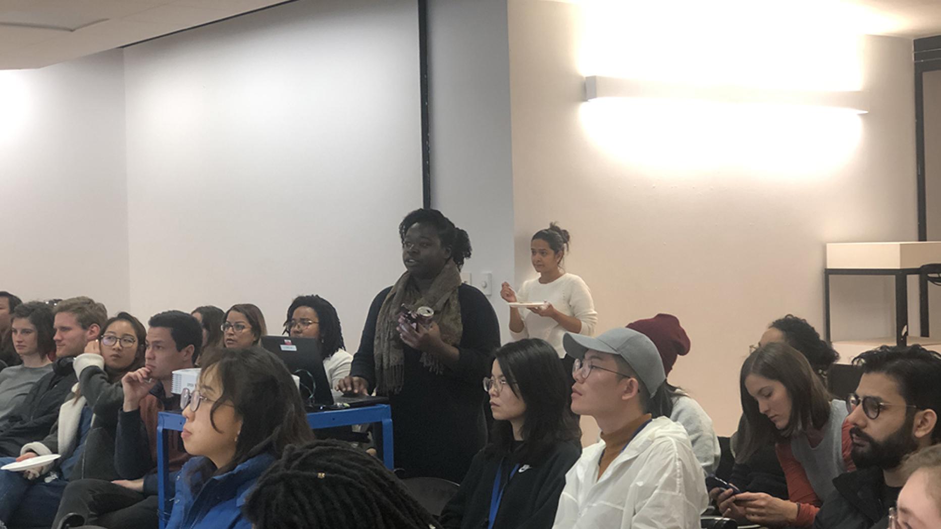 Large diverse group of students sitting and listening