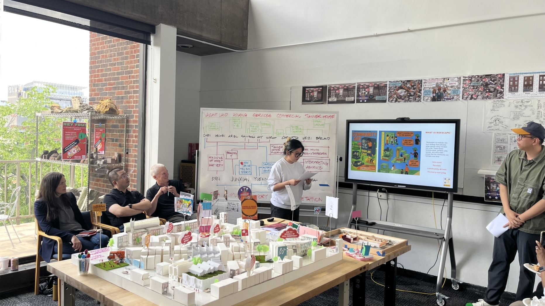 studio reviewers and presenters surround 5x5 foot model